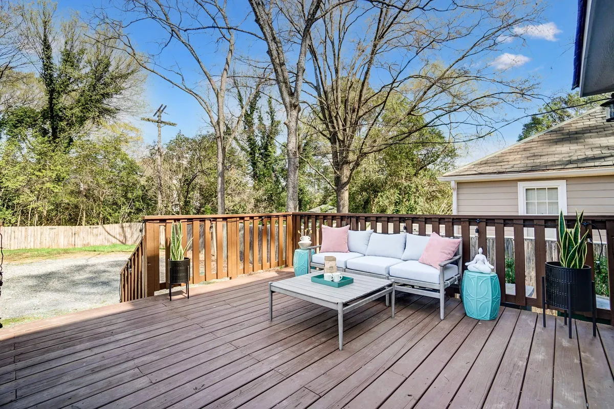 This image features a welcoming outdoor seating area surrounded by lush greenery and decorative plants. The wooden deck, comfortable furniture, and tranquil atmosphere make it perfect for relaxing with family or entertaining guests. The setting is ideal for enjoying morning coffee, sunset views, or evening stargazing, as described in the section.